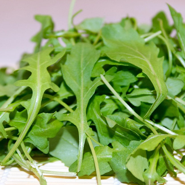 A close-up image of fresh rocket salad leaves.